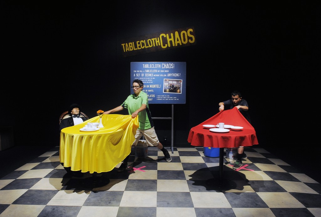 What's the trick to pulling a table cloth out from under dishes without disturbing them? Find out at the Mythbusters: The Explosive Exhibition in